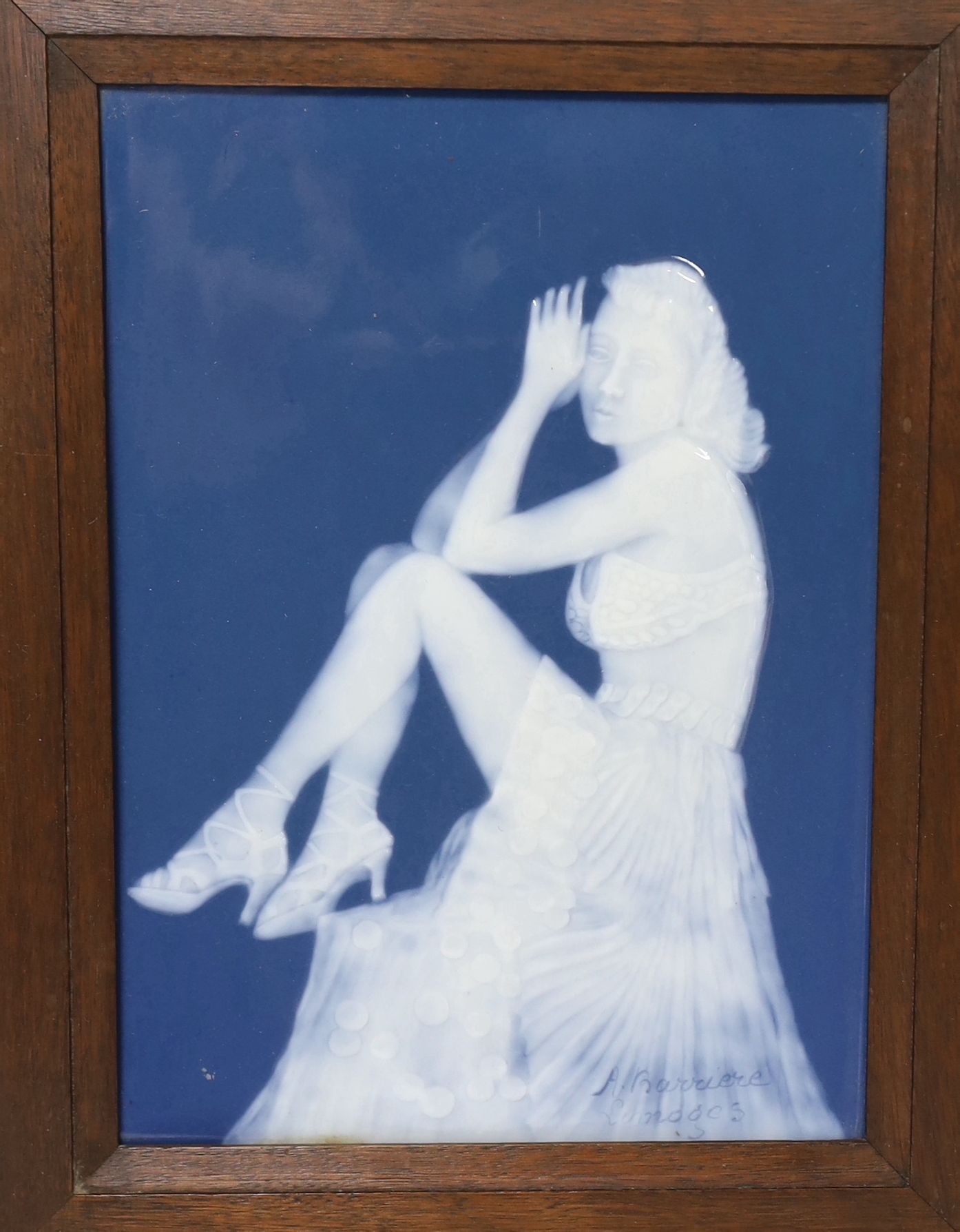An Art Deco Limoges pate sur pate plaque depicting a seated female, signed, A Barriere, framed, overall 39 x 33cm